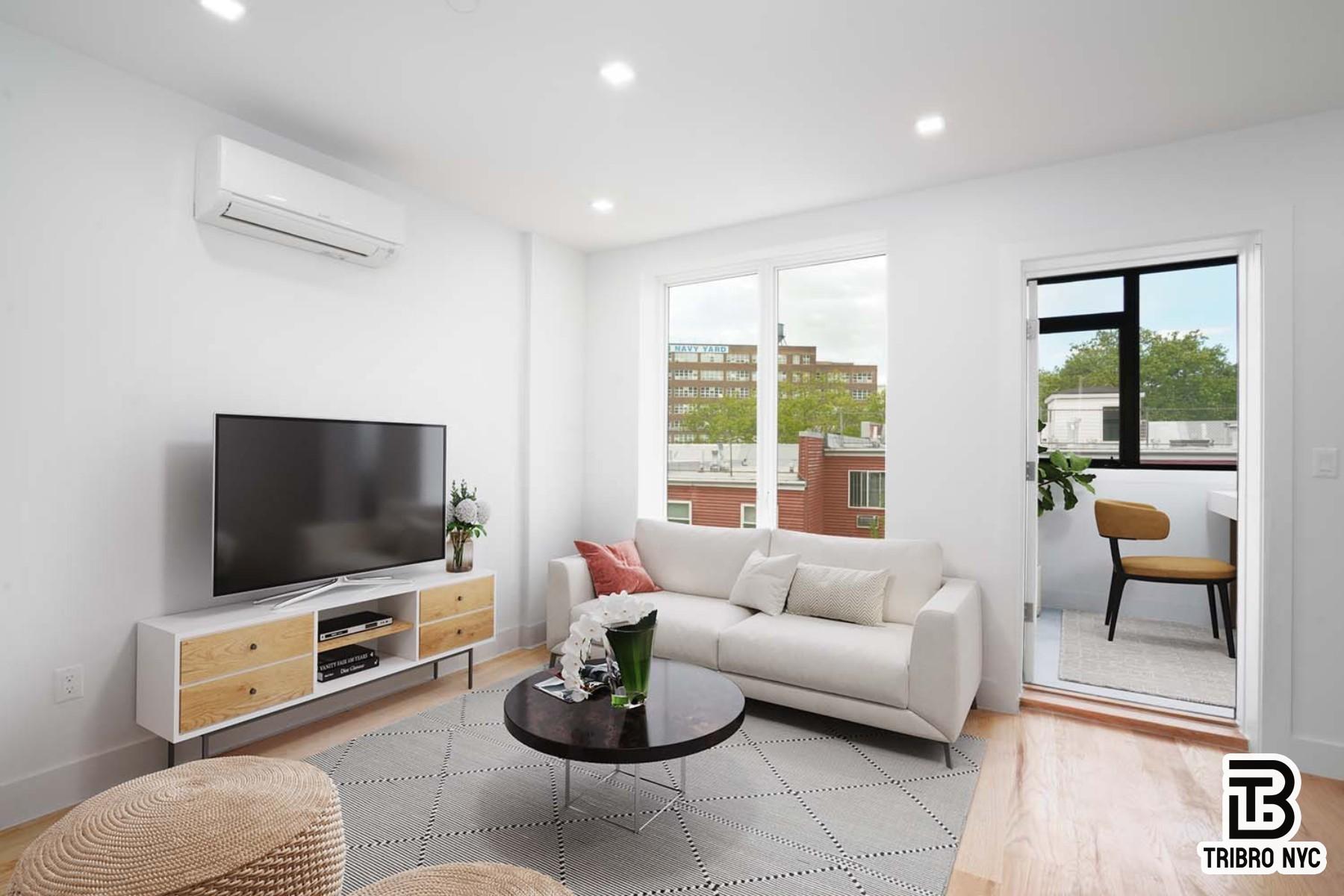 13 North Elliott Place, Unit 3 Brooklyn, NY 11205 - Photo 2 of 8 a living room with furniture and a flat screen tv