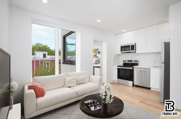 a living room with furniture and a kitchen