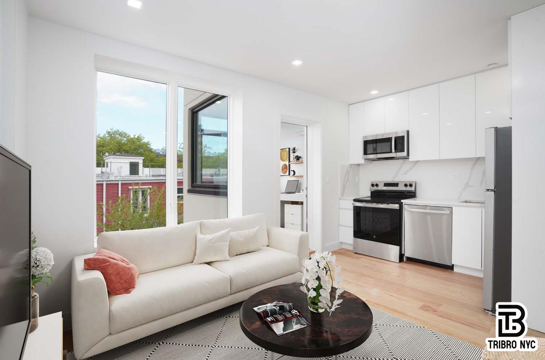 13 North Elliott Place, Unit 3 Brooklyn, NY 11205 - Photo 3 of 8 a living room with furniture and a kitchen
