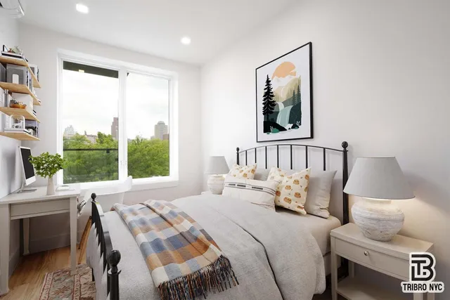 a bedroom with a bed and glass window