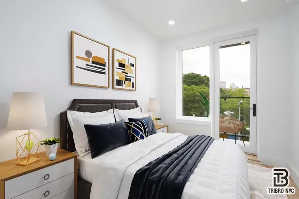 a bedroom with bed and a large window