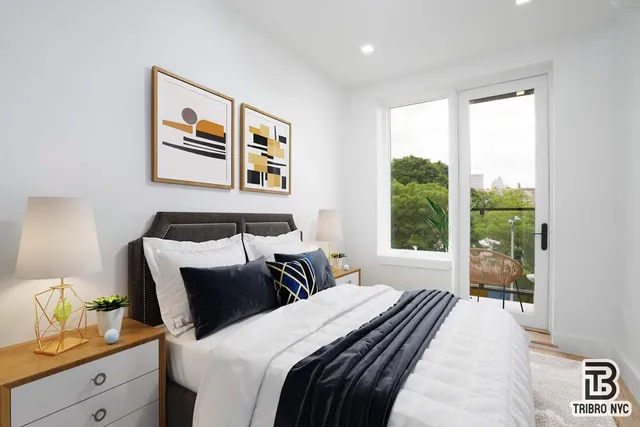 a bedroom with bed and a large window