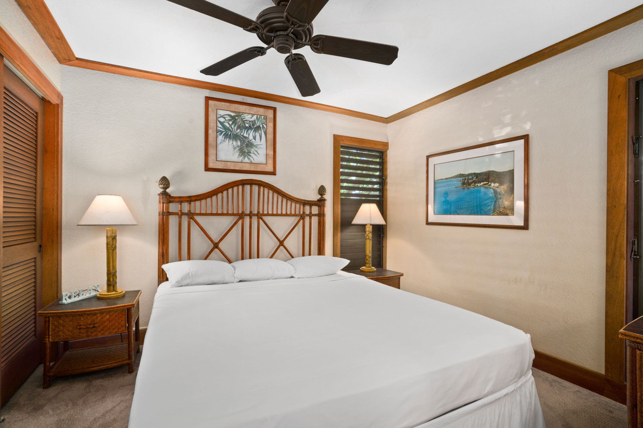 2253 Poipu Road, Unit 330 Koloa, HI 96756 - Photo 13 of 26 a bedroom with a bed and a lamp on table