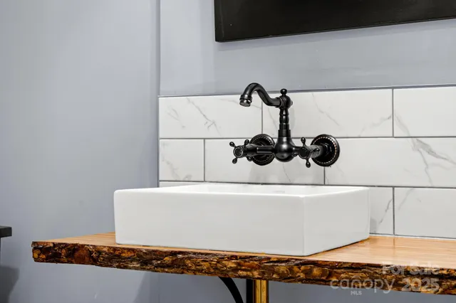 a view of a room with wooden floor fan and windows