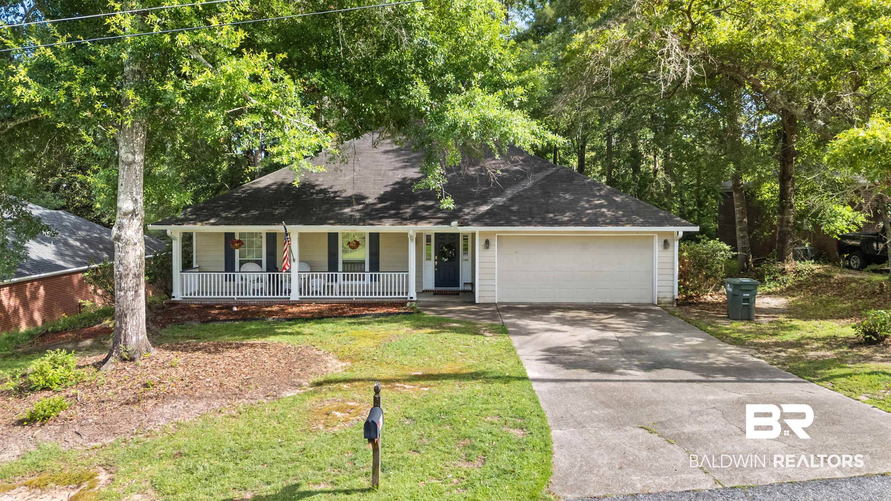 153 Lakeview Loop Daphne, AL 36526 - Photo 1 of 56 Welcome home to 153 Lakeview Loop, where mature trees, timeless appeal, and a sought-after Lake Forest location create an inviting first impression.