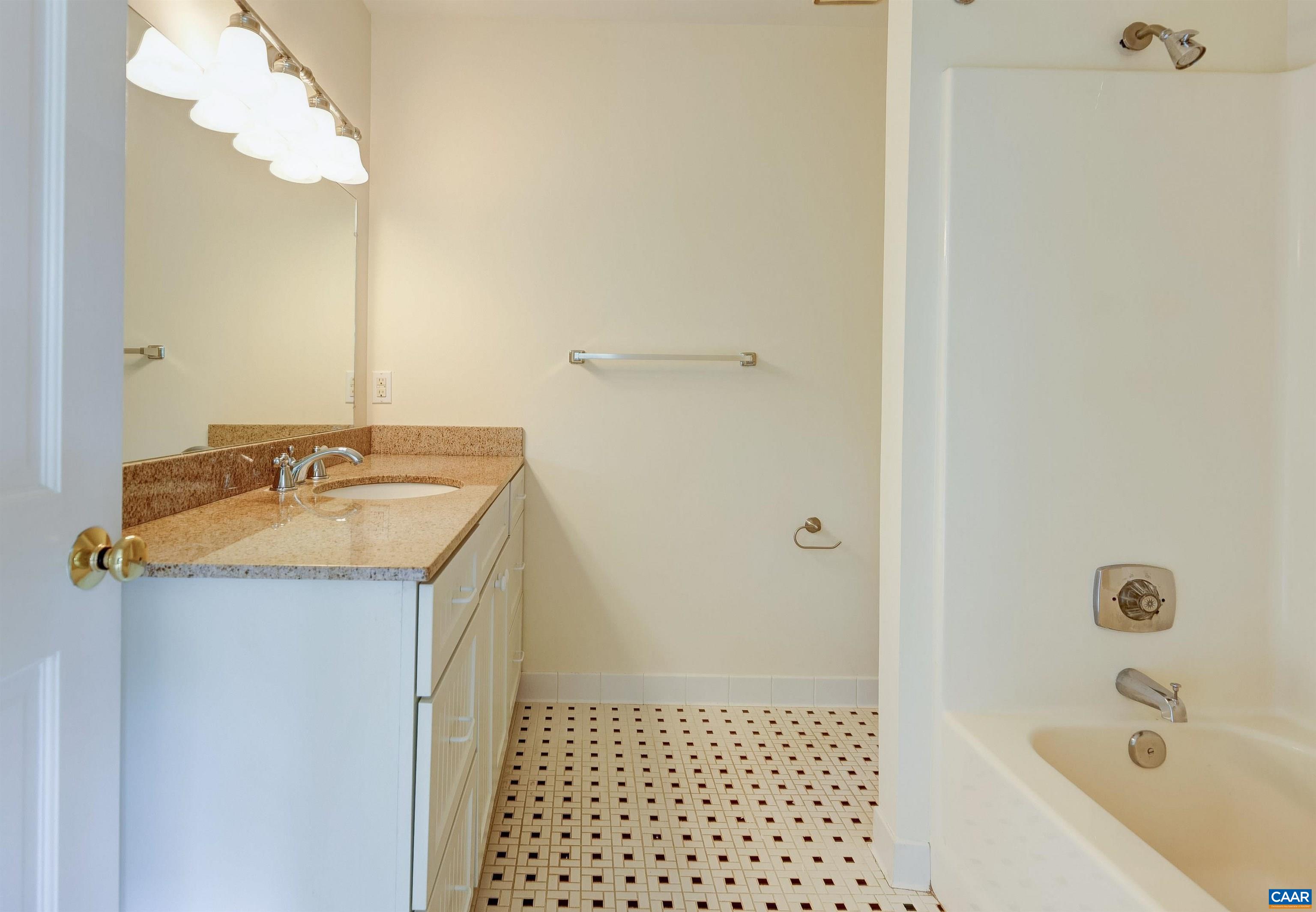 1296 Maple View Drive Charlottesville, VA 22902 - Photo 20 of 35 a bathroom with a granite countertop sink a mirror and shower