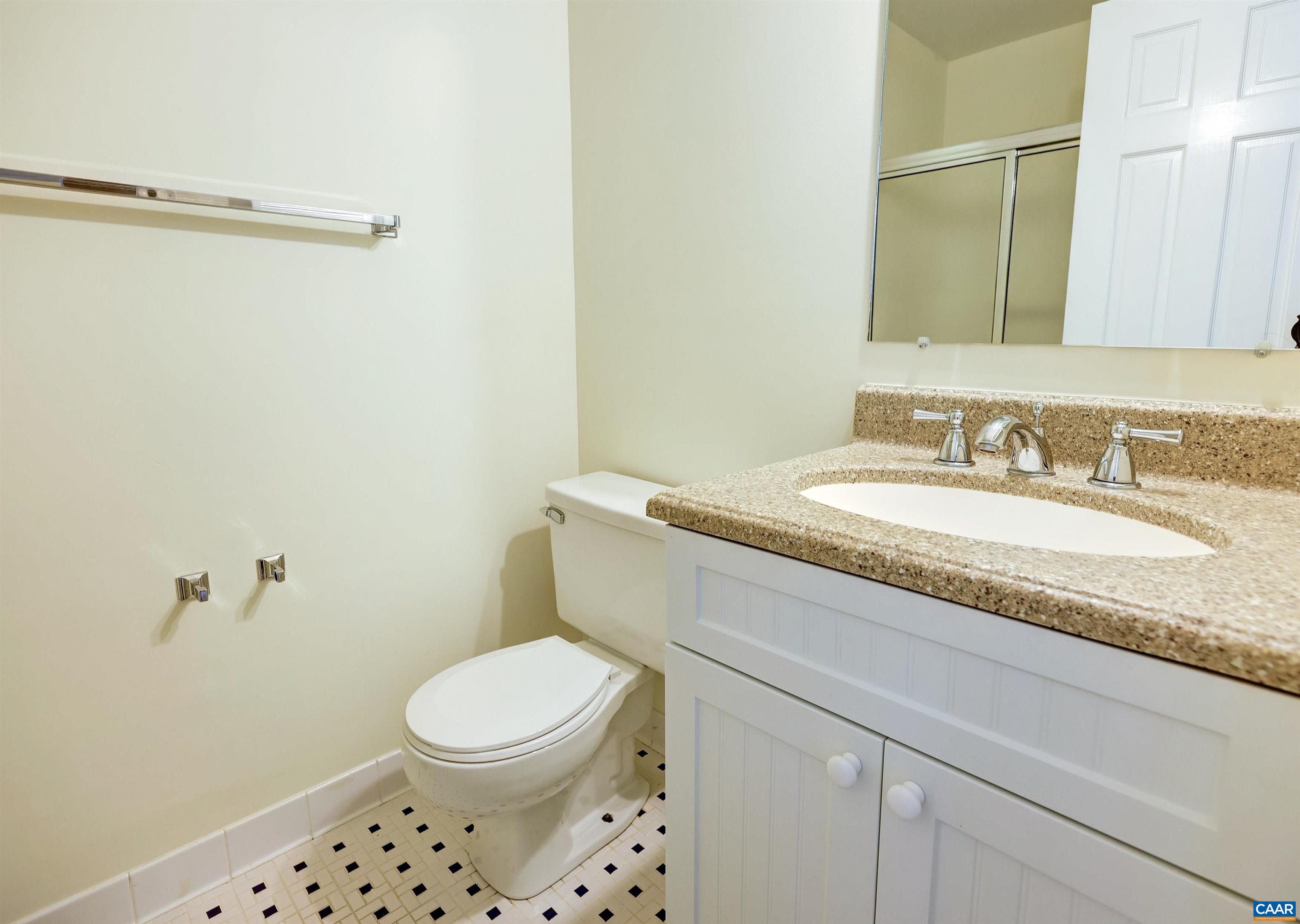 1296 Maple View Drive Charlottesville, VA 22902 - Photo 21 of 35 a bathroom with a granite countertop sink a mirror and a toilet
