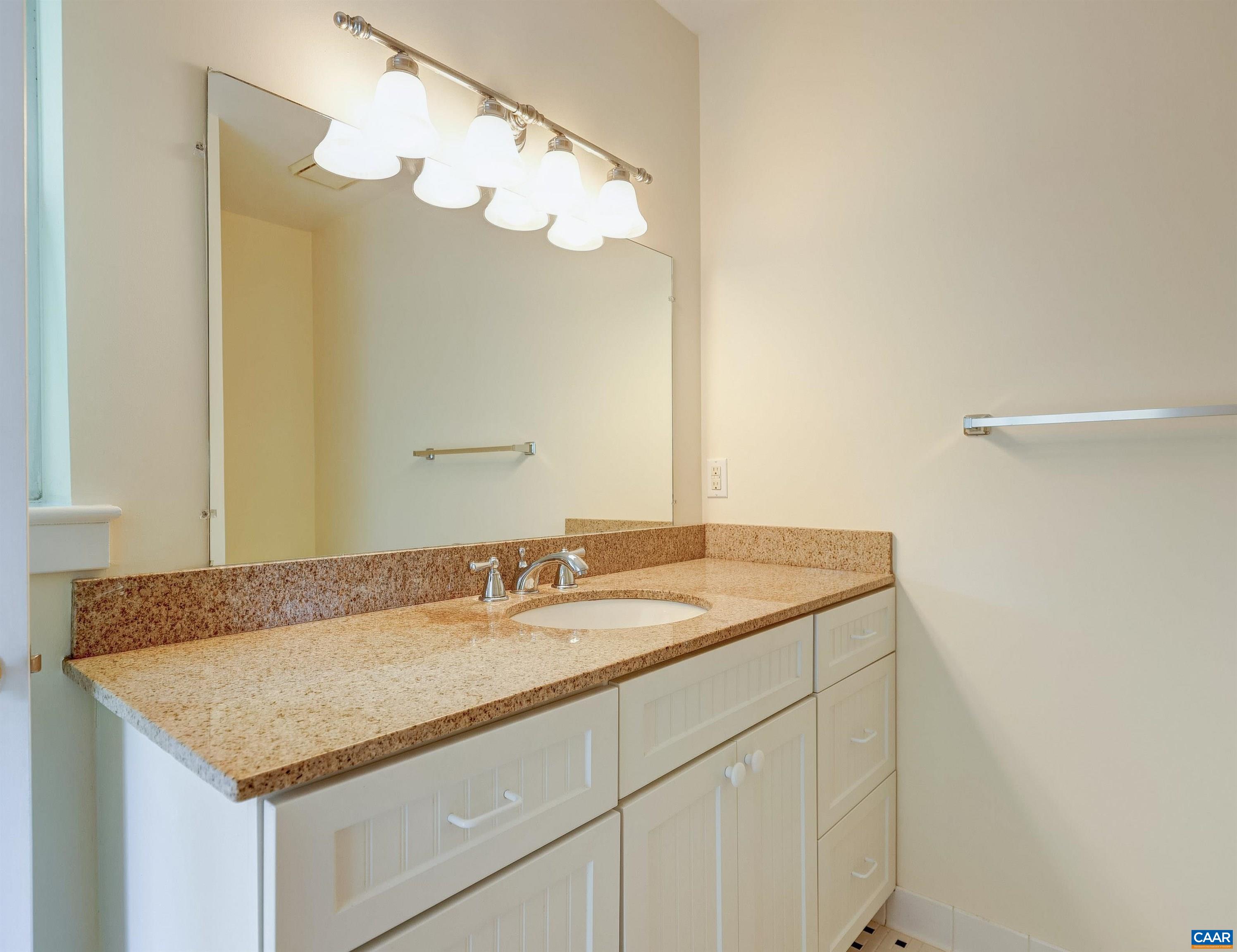 1296 Maple View Drive Charlottesville, VA 22902 - Photo 22 of 35 a bathroom with a granite countertop sink and a mirror