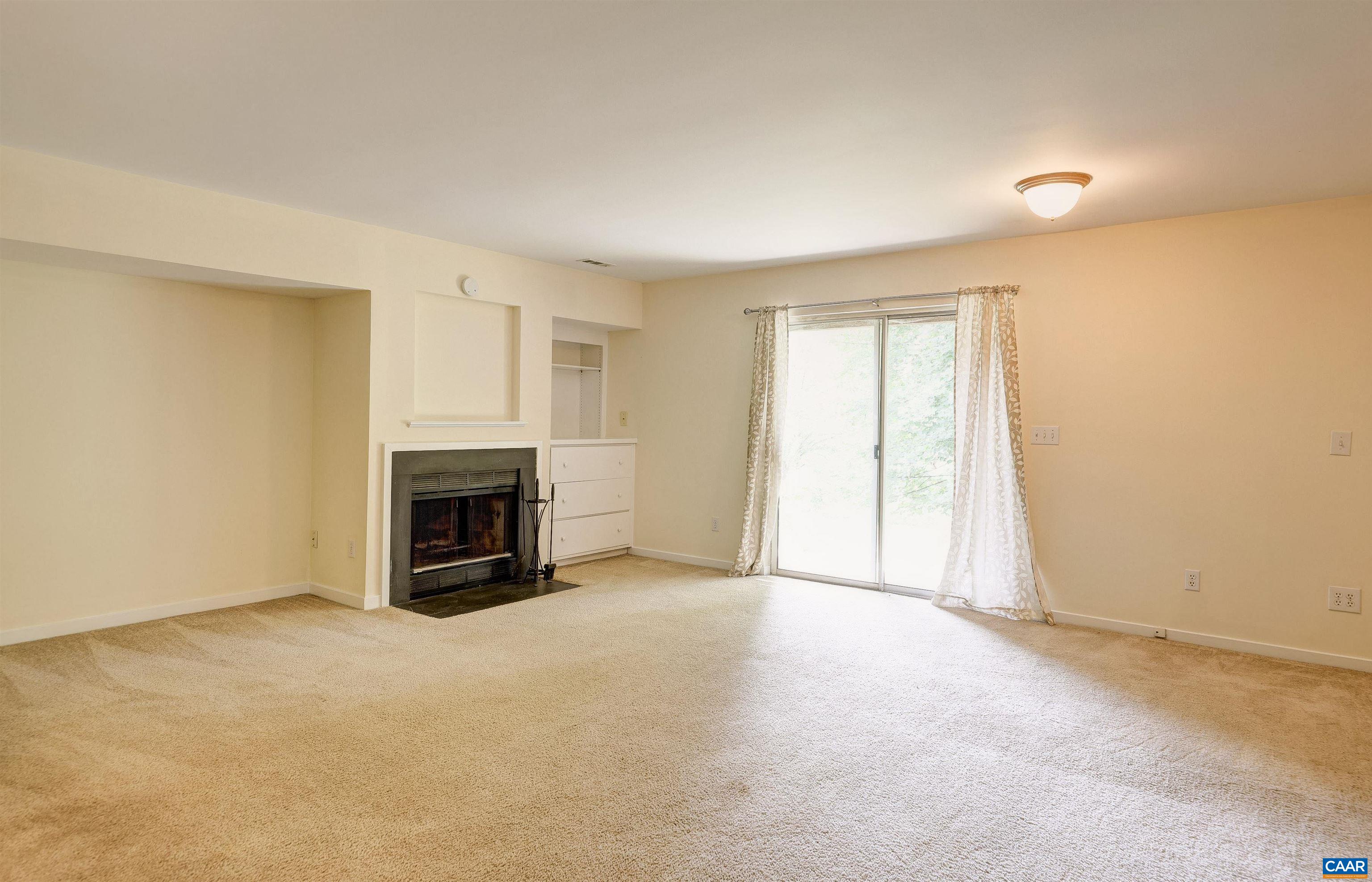 1296 Maple View Drive Charlottesville, VA 22902 - Photo 23 of 35 an empty room with fireplace and chandelier