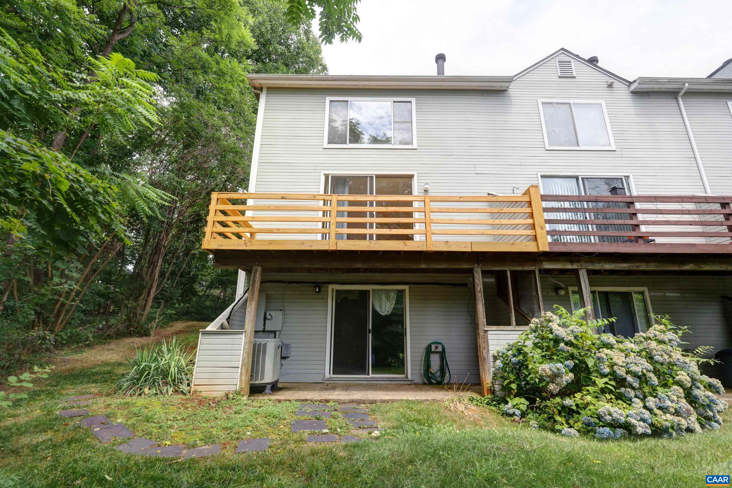 1296 Maple View Drive Charlottesville, VA 22902 - Photo 30 of 35 a view of a white house with large windows and a yard