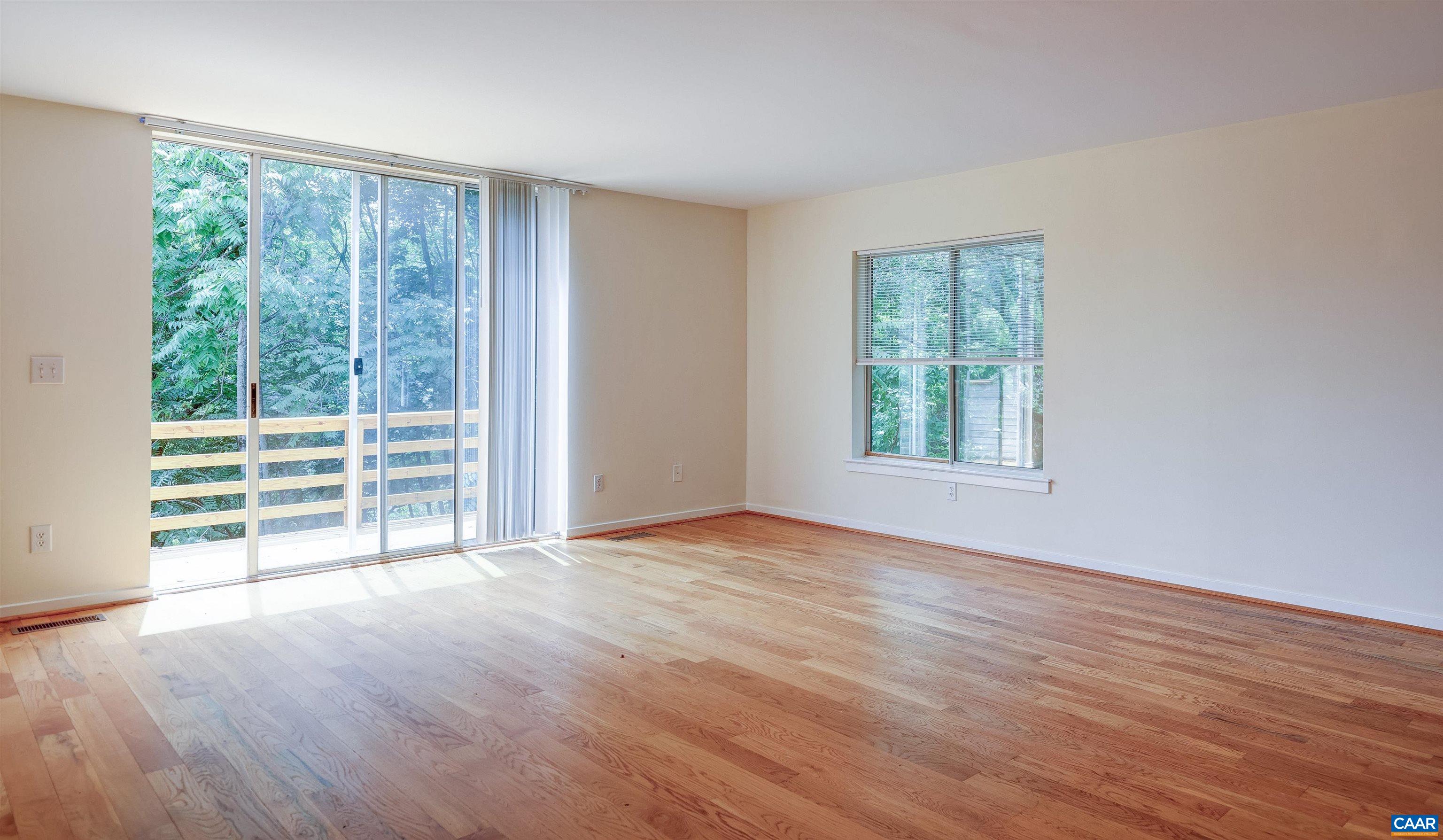 1296 Maple View Drive Charlottesville, VA 22902 - Photo 3 of 35 a view of an empty room with wooden floor and a window