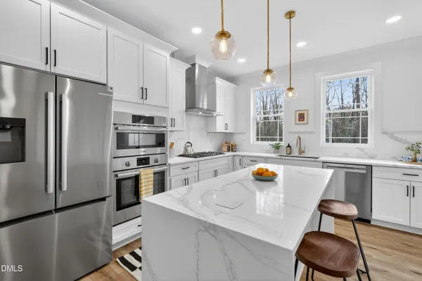 a kitchen with a refrigerator a sink and cabinets