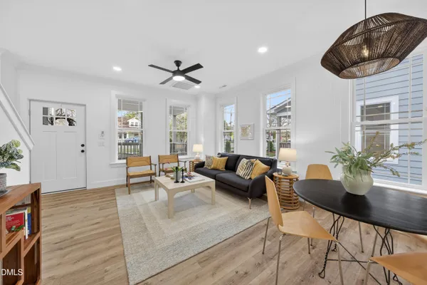a living room with furniture and a wooden floor
