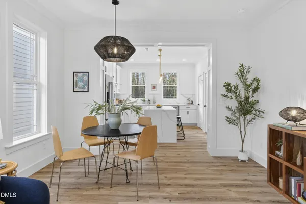 a view of a dining room with furniture window and wooden floor