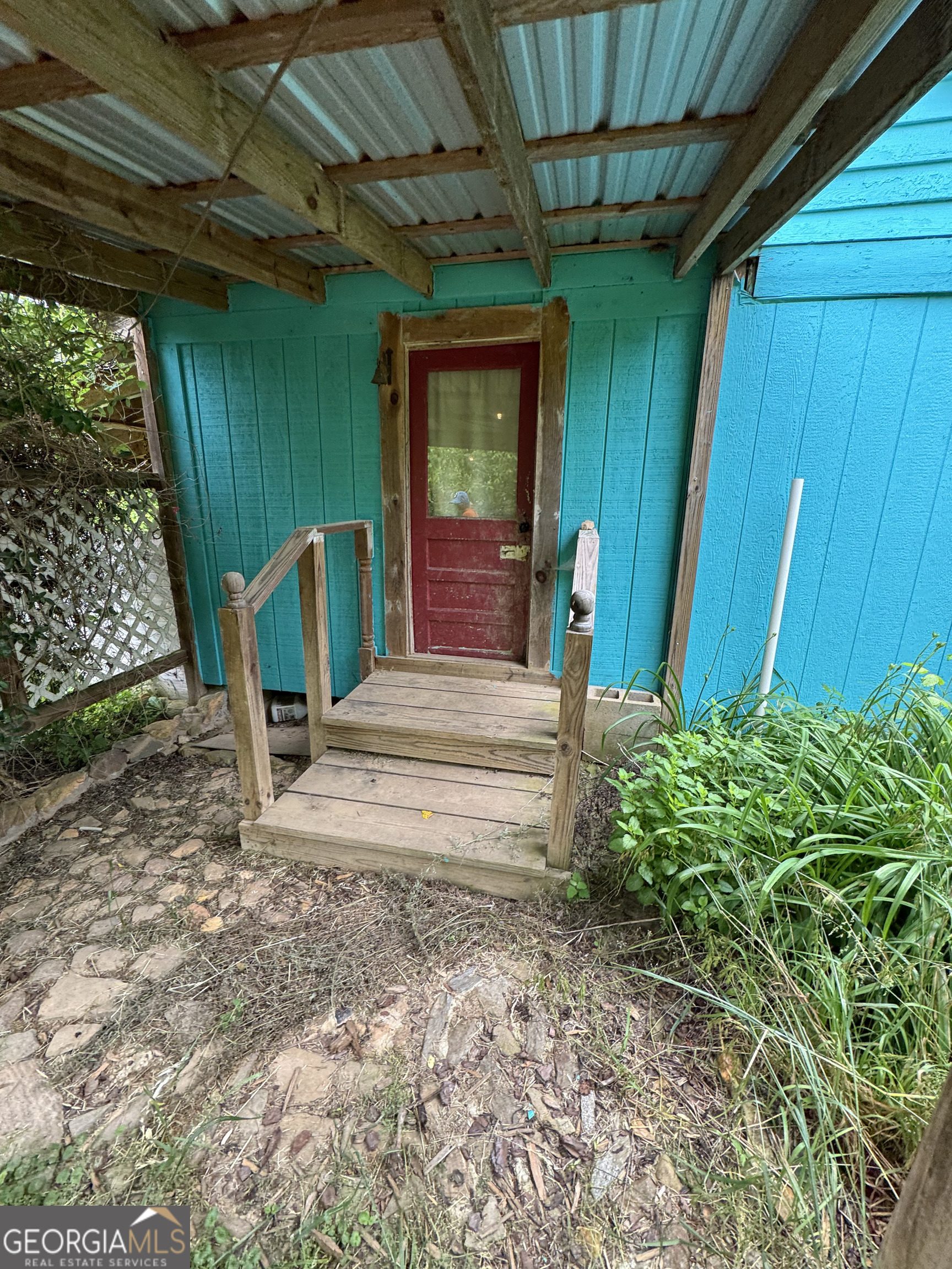 9122 Blue Ridge Highway Blairsville, GA 30512 - Photo 12 of 42 a view of a porch with a table and chairs