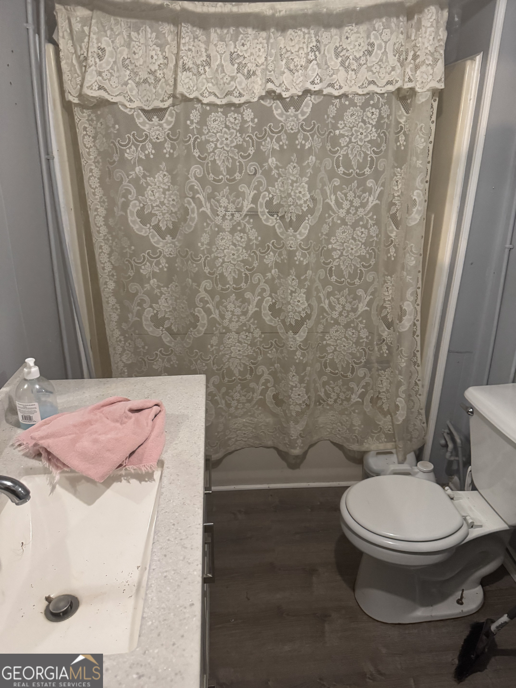 9122 Blue Ridge Highway Blairsville, GA 30512 - Photo 35 of 42 a bathroom with a toilet and a shower curtain