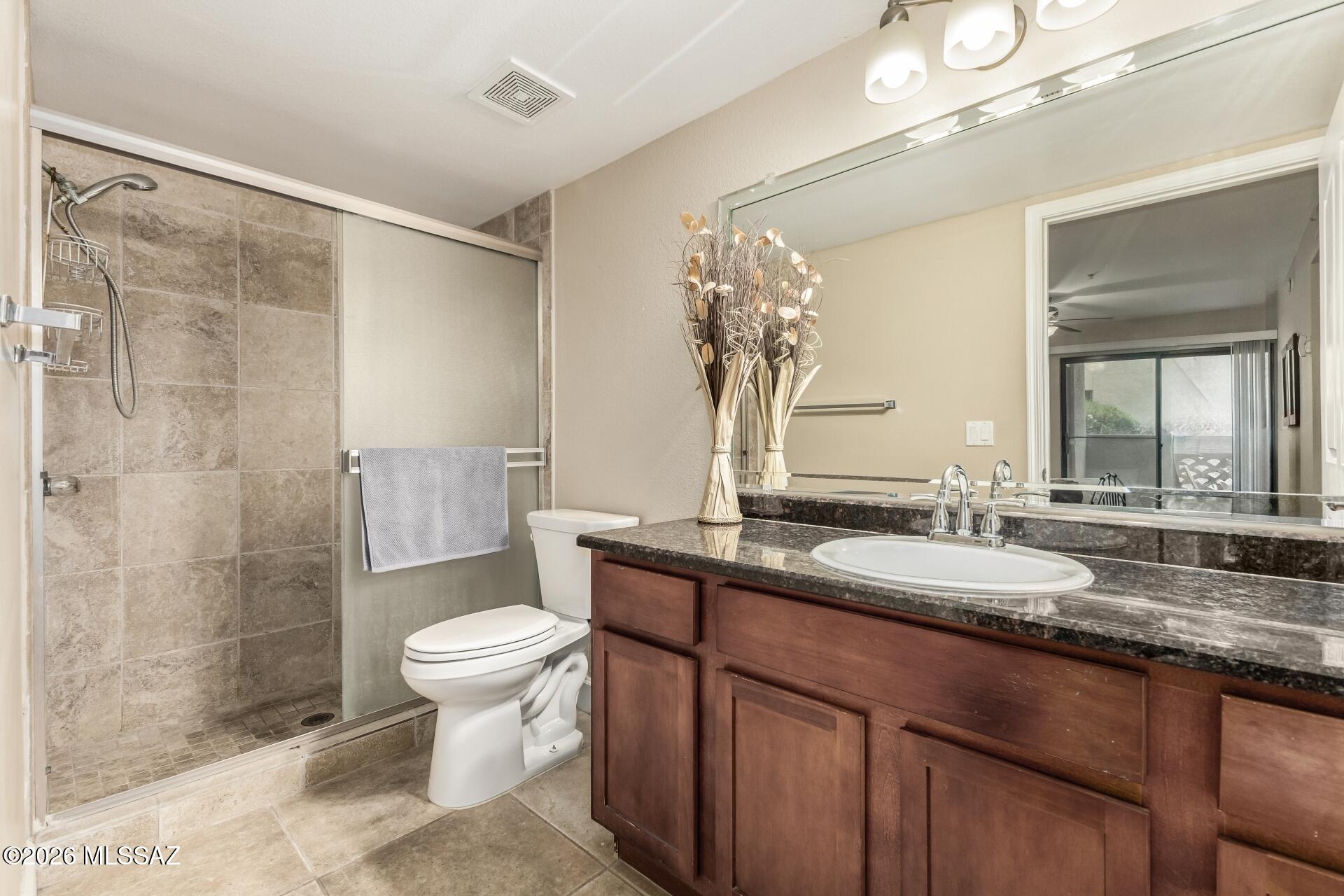 5751 North Kolb Road, Unit 25103 Tucson, AZ 85750 - Photo 9 of 24 Primary bath with walk in shower, tile surround.