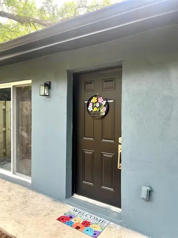 a living room with furniture a flat screen tv and a large window