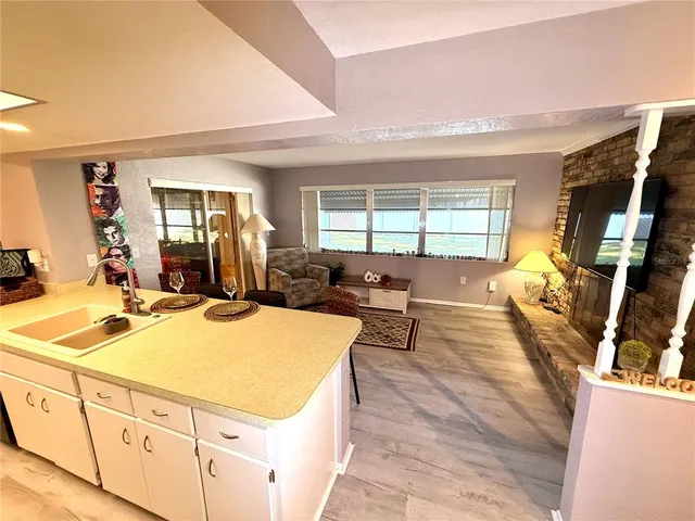 a view of a hallway with wooden floor and entryway