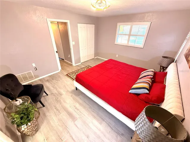 a view of a patio with table and chairs and wooden fence