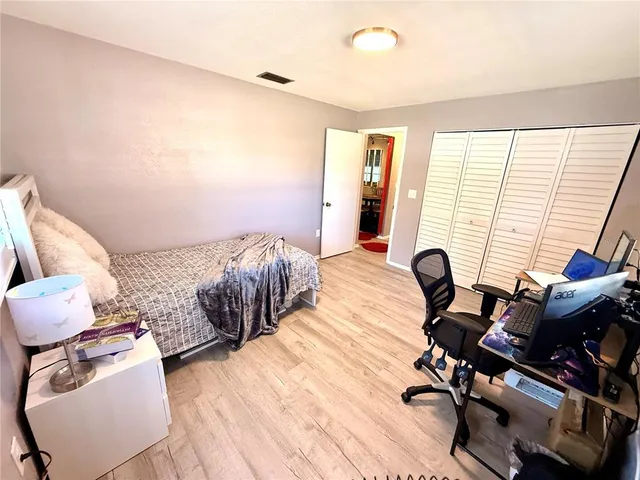 a kitchen with stainless steel appliances kitchen island granite countertop a refrigerator and a sink