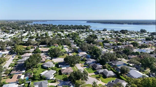 a living room with furniture fireplace and a large window