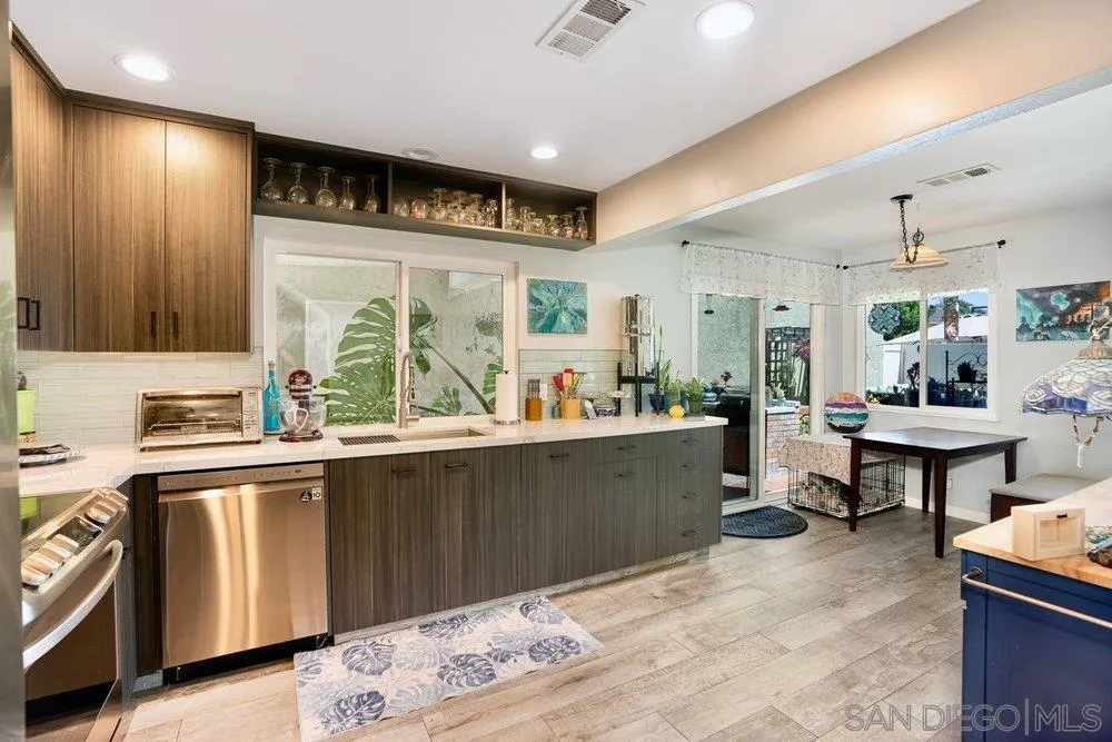 13358 Birch Tree Lane Poway, CA 92064 - Photo 6 of 16 a kitchen with stainless steel appliances kitchen island granite countertop a sink and cabinets