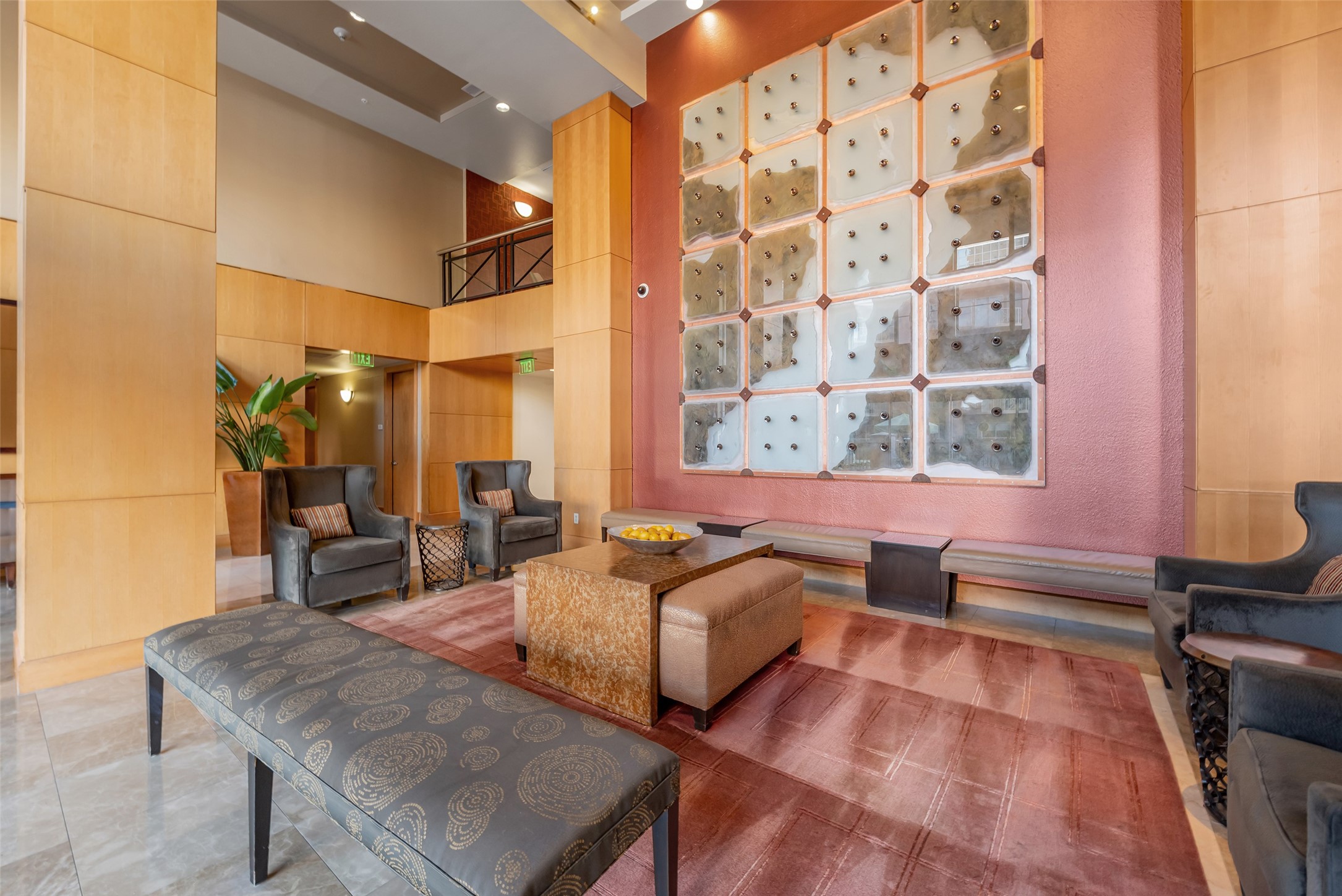 3505 Sage Road, Unit 2210 Houston, TX 77056 - Photo 25 of 40 A stunning condo lobby with soaring ceilings and thoughtfully arranged seating, creating a bright, sophisticated, and welcoming first impression, an elegant space to meet and greet your guests. Behind the wall is the concierge and security station.