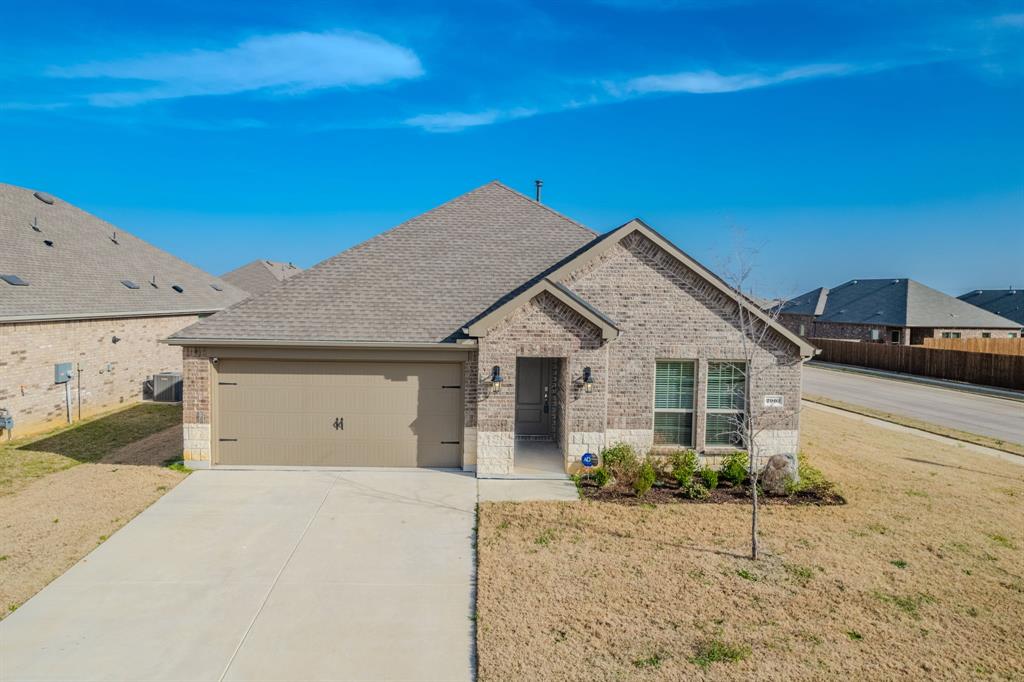 2902 Trusting Way Aubrey, TX 76227 - Photo 3 of 38 Brick and stone veneer exterior with a gabled roofline