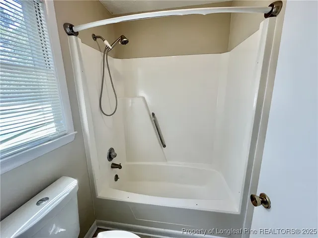 a bathroom with a shower and a toilet