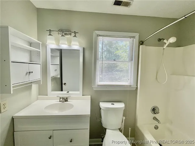 a bathroom with a sink toilet a mirror and shower