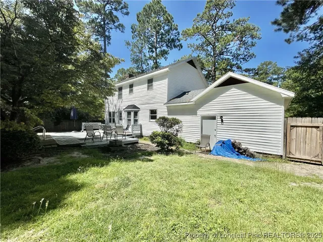 a view of a house with backyard and sitting area