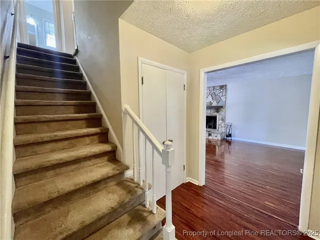 a view of entryway and hall with wooden floor