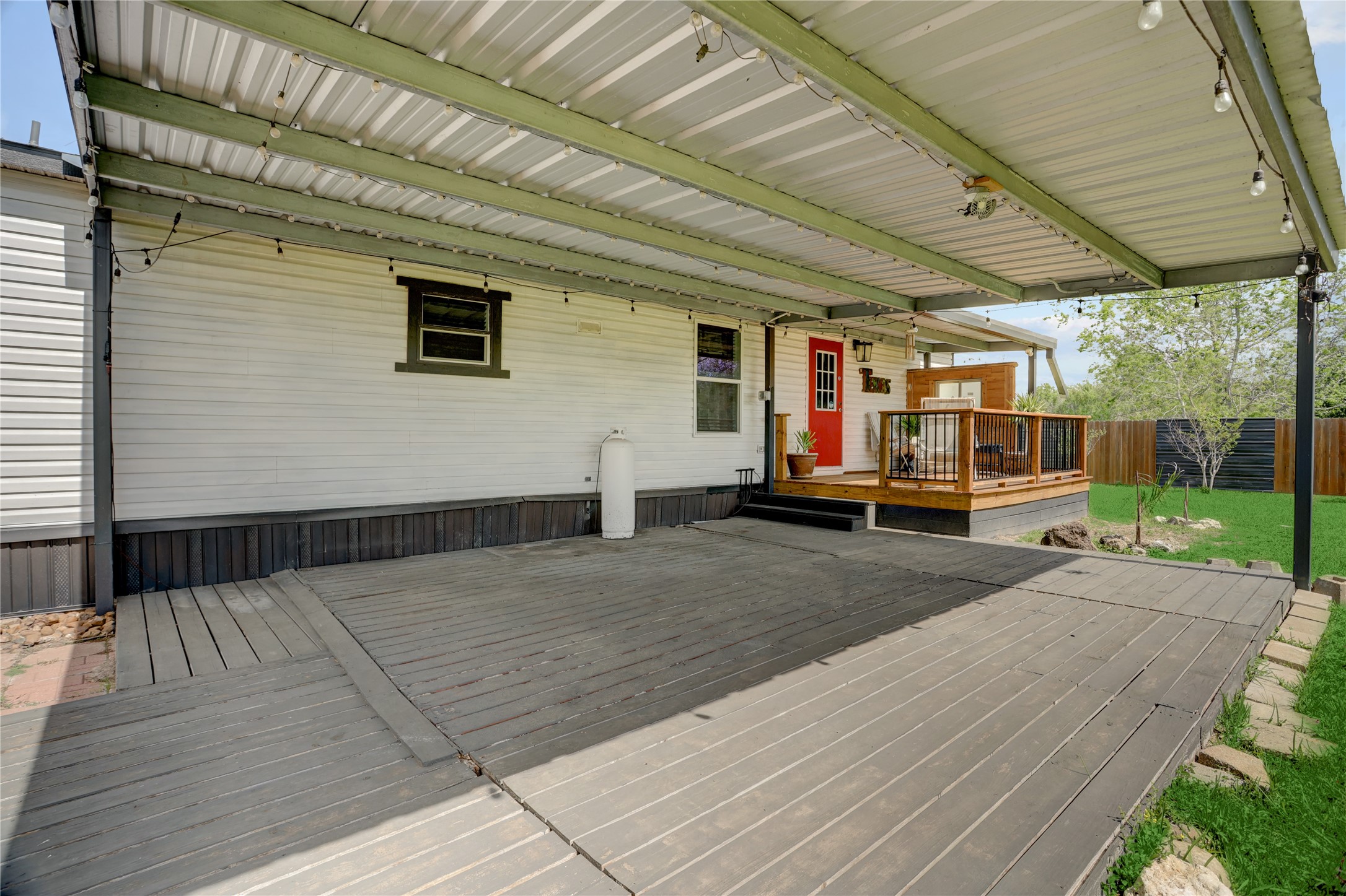 2811 Pisces Street Rosenberg, TX 77469 - Photo 26 of 34 Covered patio with string lights, perfect for outdoor gatherings.