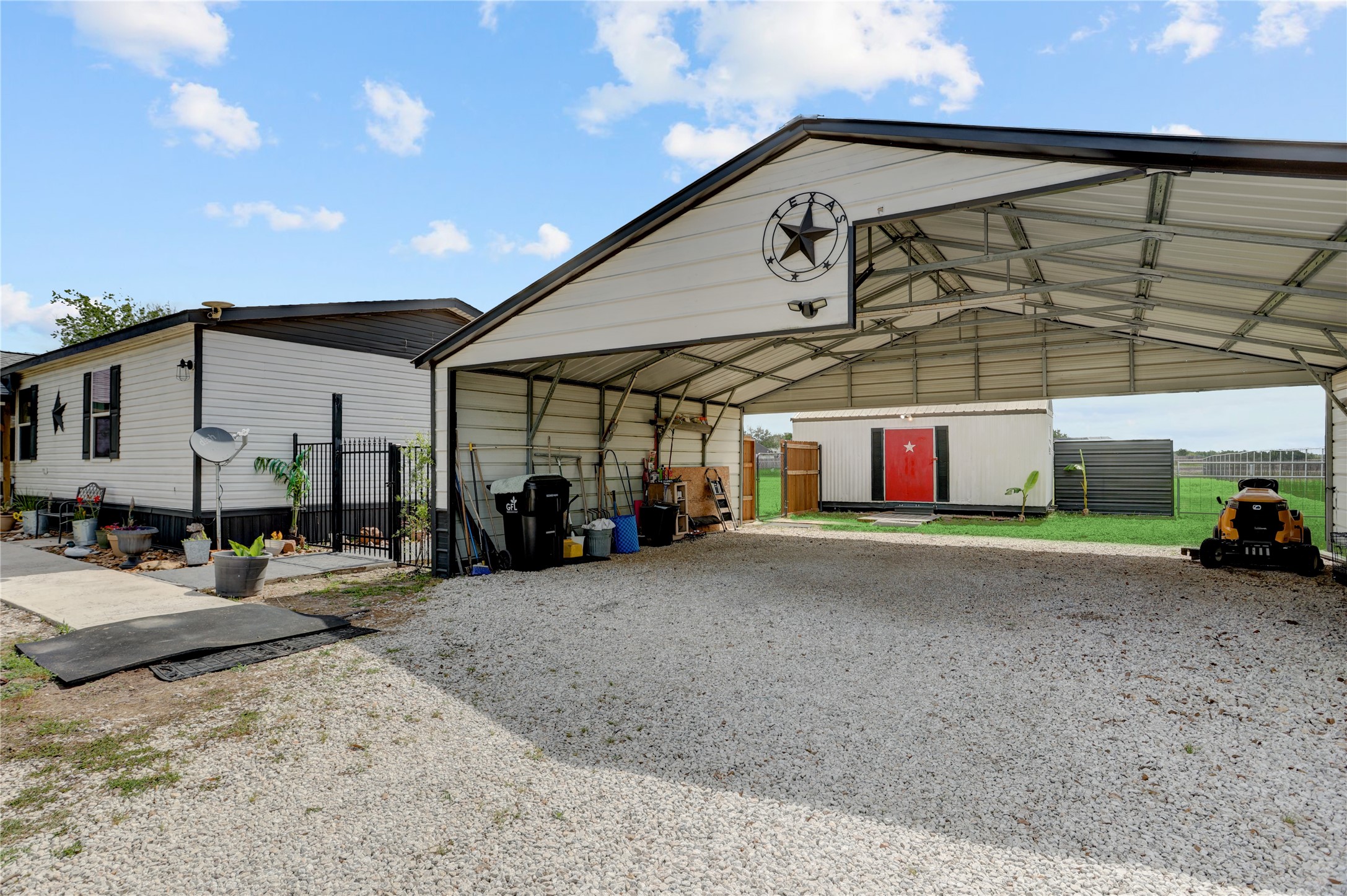2811 Pisces Street Rosenberg, TX 77469 - Photo 7 of 34 Large metal carport, suitable for vehicles or storage.