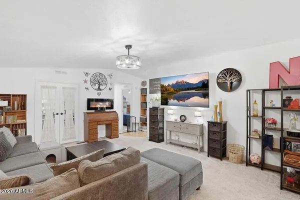 a living room with furniture a flat screen tv and a fireplace