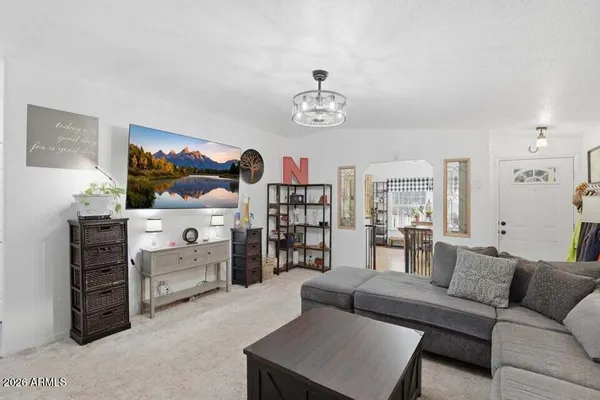 a living room with furniture cabinets and window
