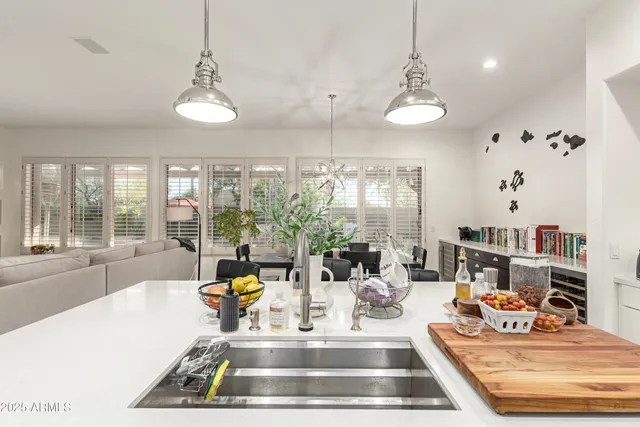a living room with fireplace furniture and a large window