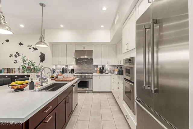 a kitchen with refrigerator a sink and cabinets