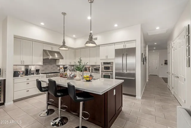 a large kitchen with a table and chairs