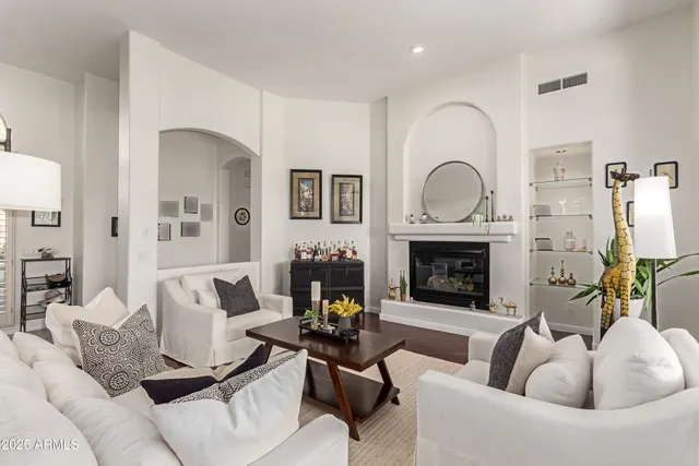 a living room with furniture and a fireplace