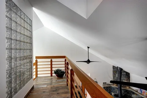 a view of hallway with stairs and wooden floor