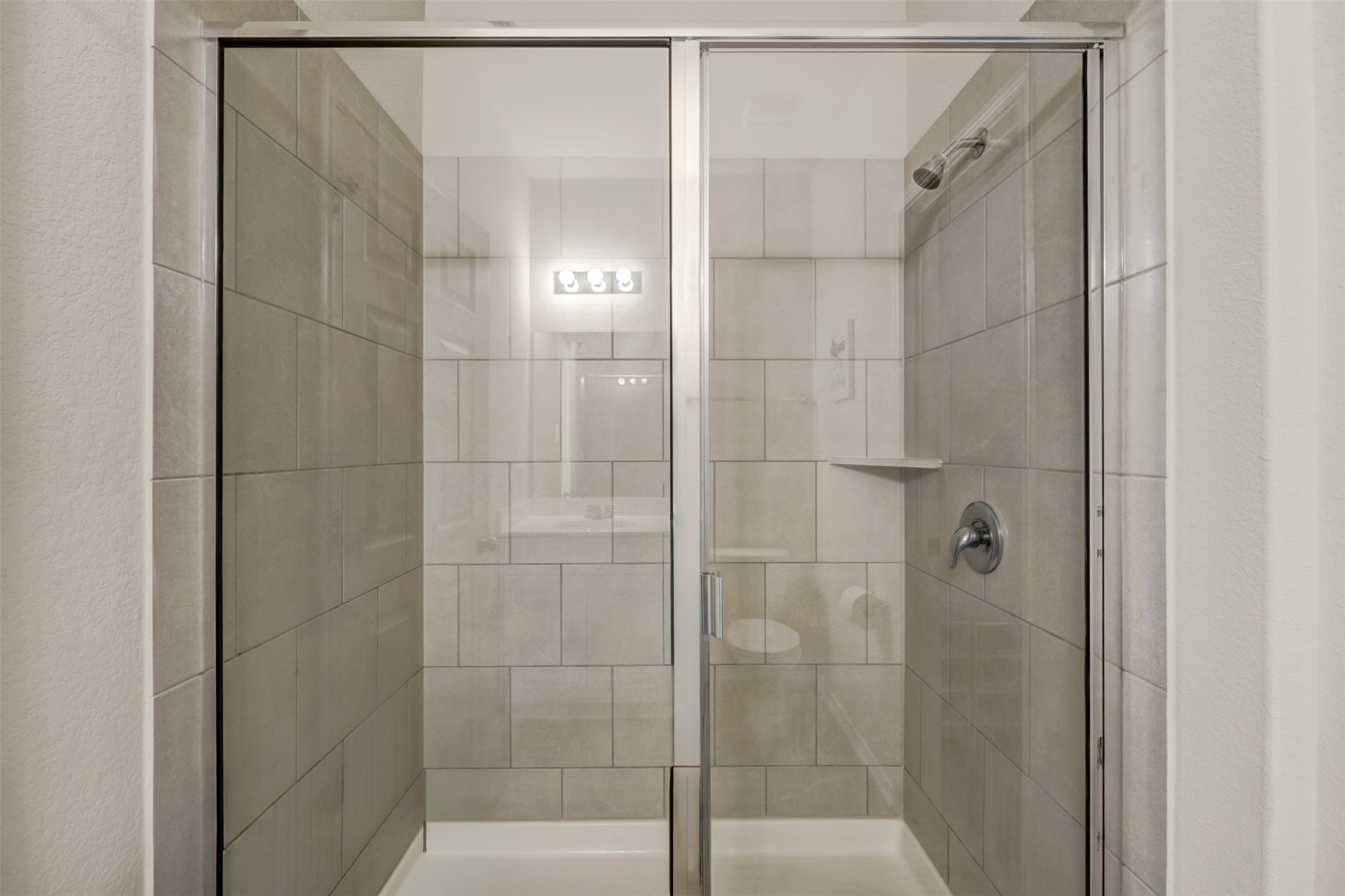 213 Ibis Falls Loop Jarrell, TX 76537 - Photo 19 of 37 A well-appointed, contemporary shower with sleek glass enclosure.