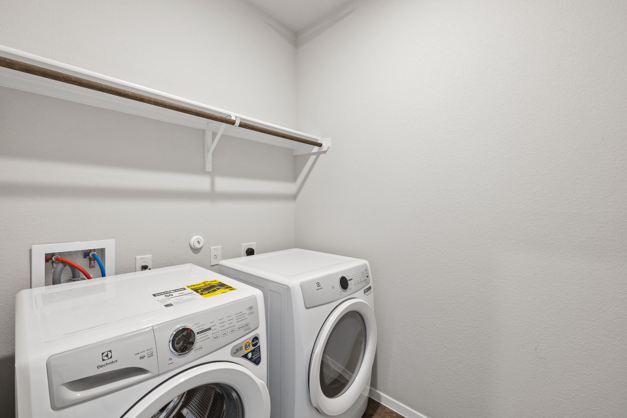 2460 Winding Creek Road Kyle, TX 78640 - Photo 17 of 20 A well-appointed laundry area offers convenient appliance hookups and a practical overhead shelf.