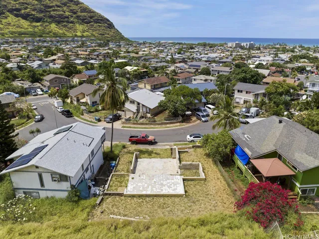 an aerial view of a house with a yard
