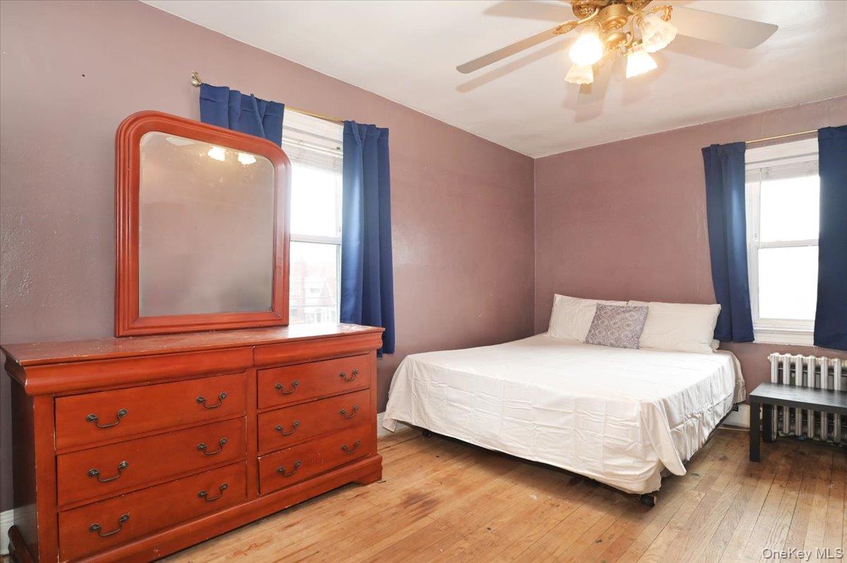 130-71 225th Street Queens, NY 11413 - Photo 18 of 26 a bedroom with a bed and a mirror on dresser