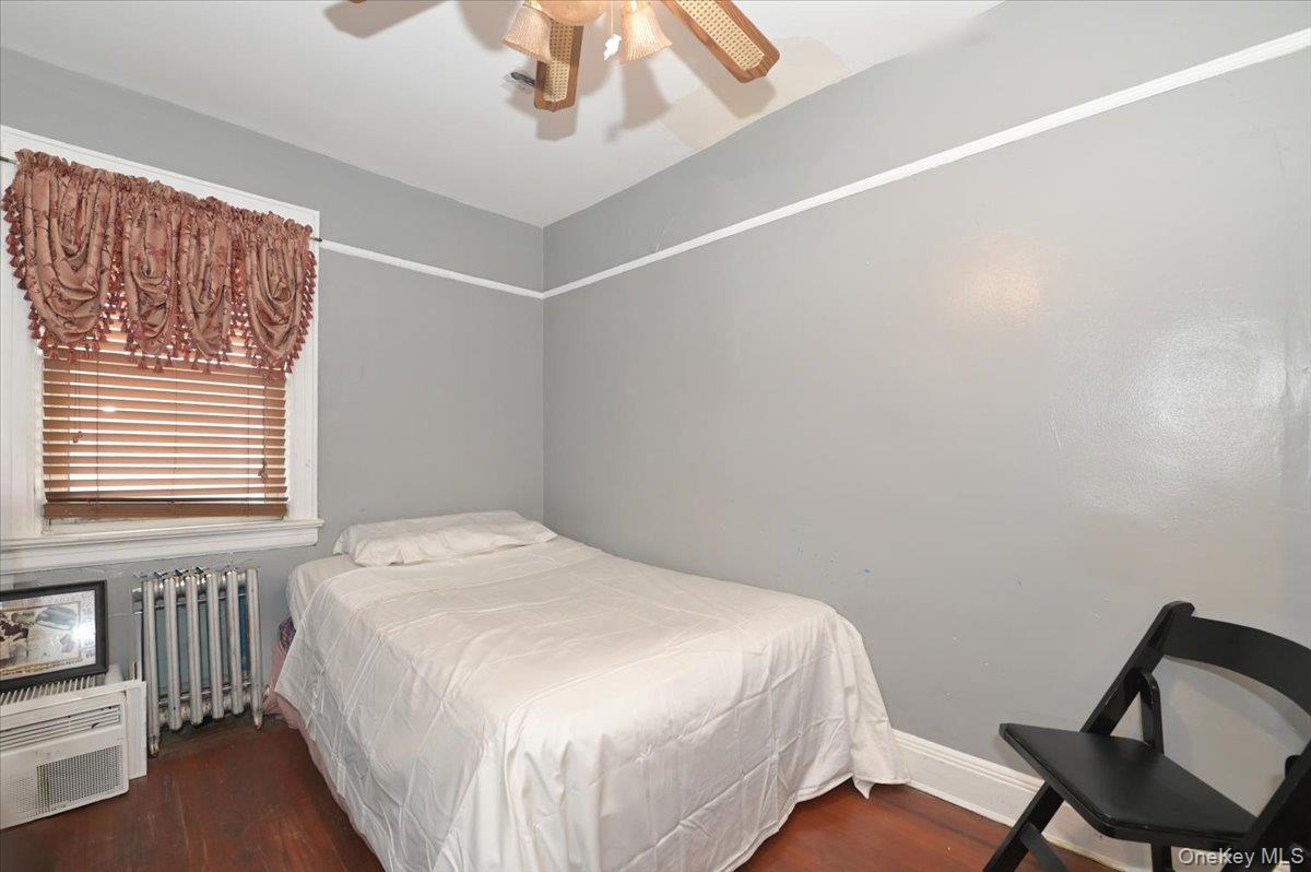 130-71 225th Street Queens, NY 11413 - Photo 19 of 26 a bedroom with a bed and a chair