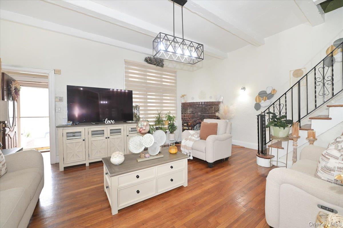130-71 225th Street Queens, NY 11413 - Photo 20 of 26 a living room with furniture and a flat screen tv