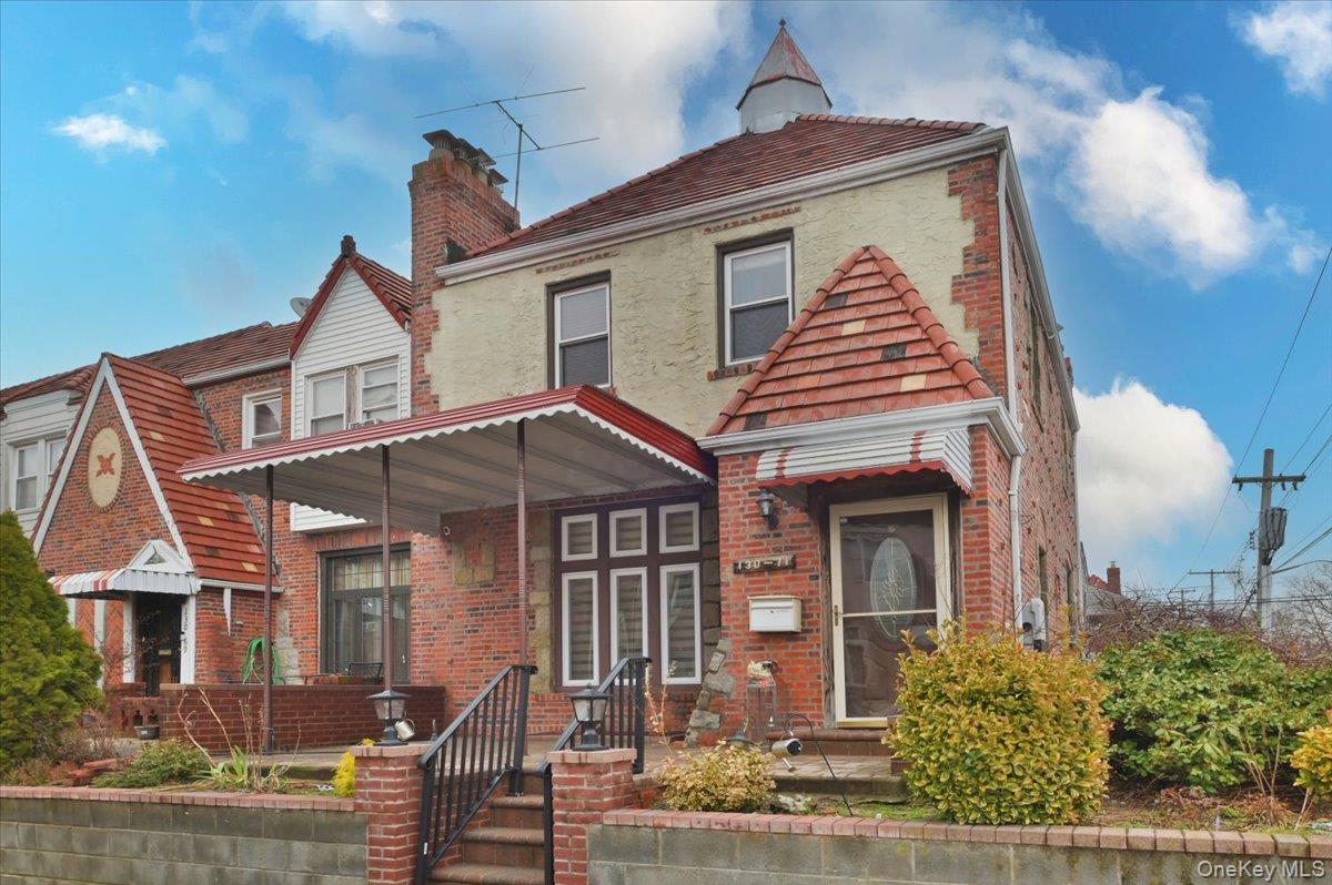 130-71 225th Street Queens, NY 11413 - Photo 2 of 26 front view of a house with a porch