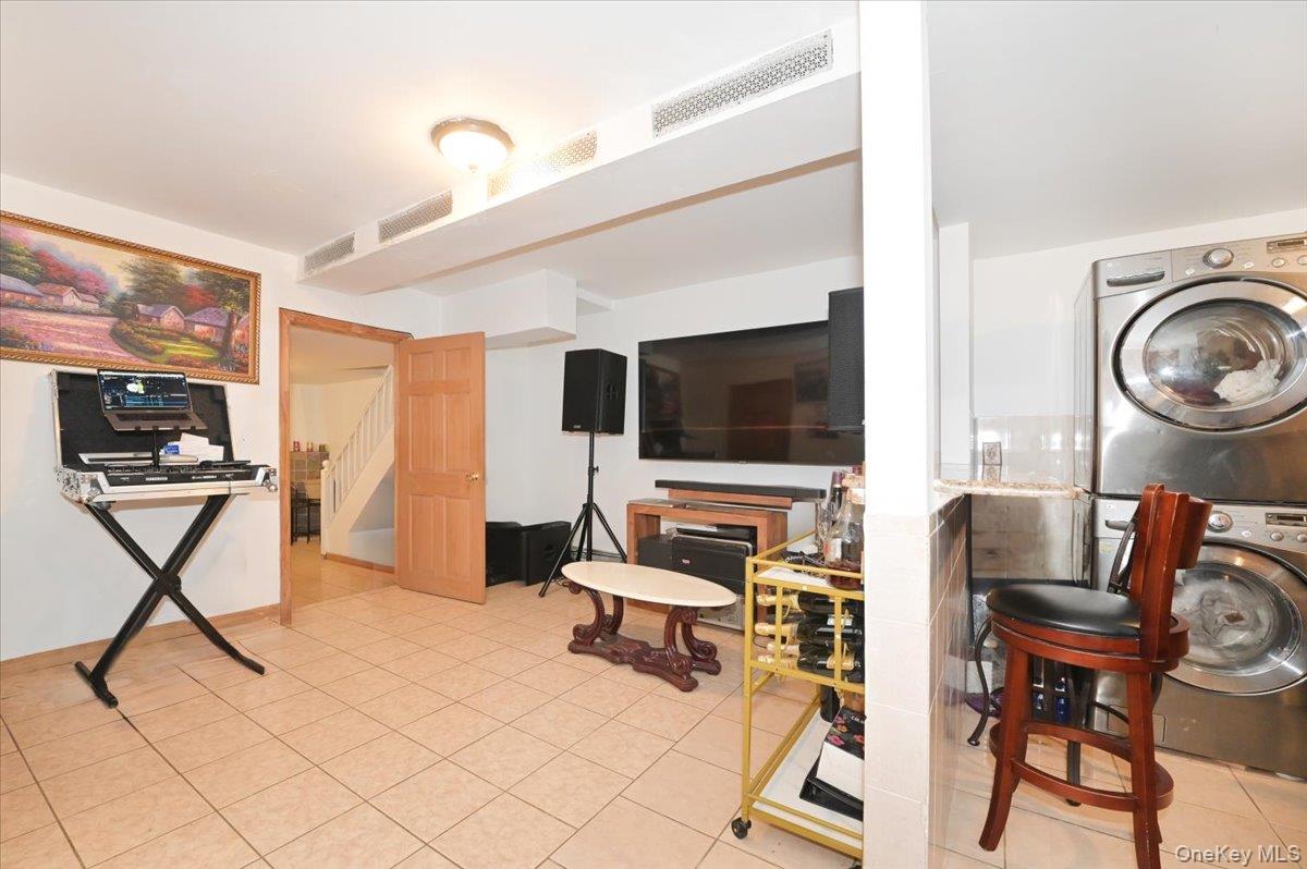 130-71 225th Street Queens, NY 11413 - Photo 21 of 26 a living room with furniture and a flat screen tv